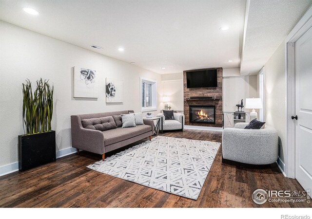 living room featuring a fireplace and dark hardwood / wood-style floors