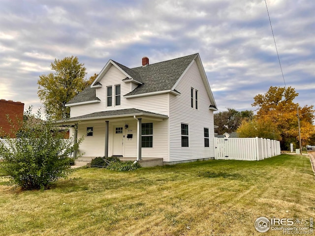 304 S High School Ave, Holyoke, CO 80734 - view of front facade featuring roof with shingles, a porch, and a chimney