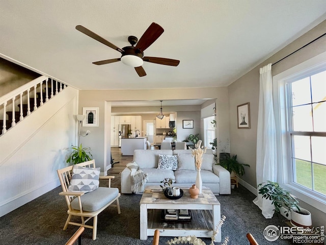 304 S High School Ave, Holyoke, CO 80734 - living area with a ceiling fan and dark colored carpet
