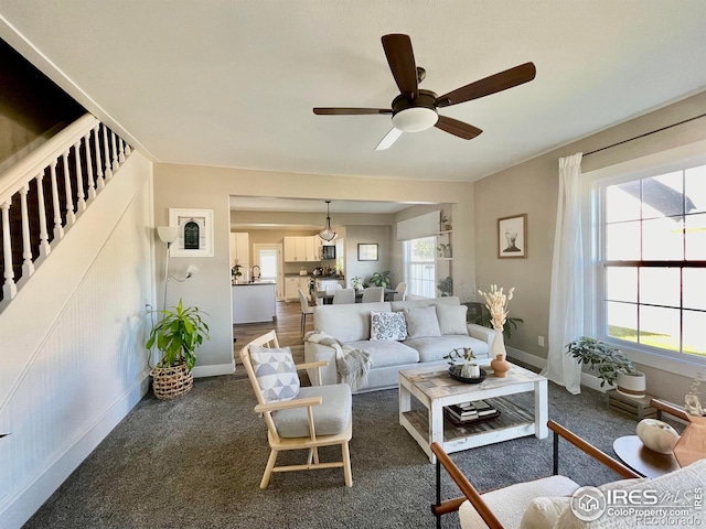 304 S High School Ave, Holyoke, CO 80734 - living area with dark colored carpet and a ceiling fan