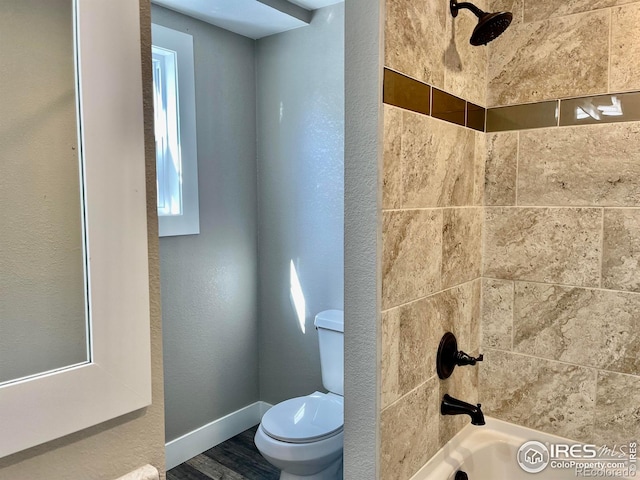 304 S High School Ave, Holyoke, CO 80734 - bathroom featuring shower / washtub combination, wood finished floors, and a textured wall