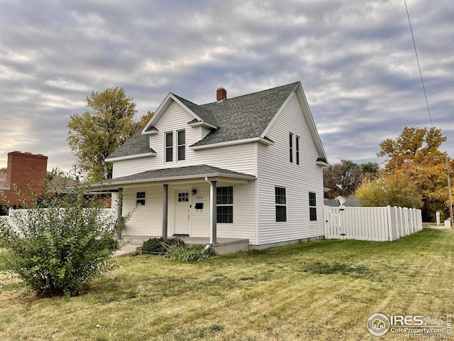 304 S High School Ave, Holyoke, CO 80734 - view of front facade featuring a porch, roof with shingles, a chimney, and a gate