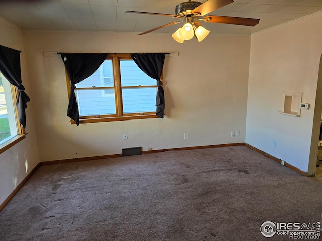 unfurnished room with carpet floors, plenty of natural light, and ceiling fan