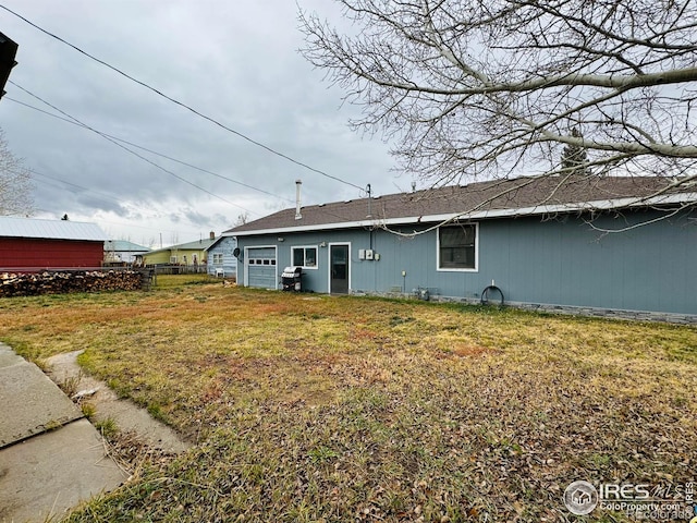 back of house with a lawn