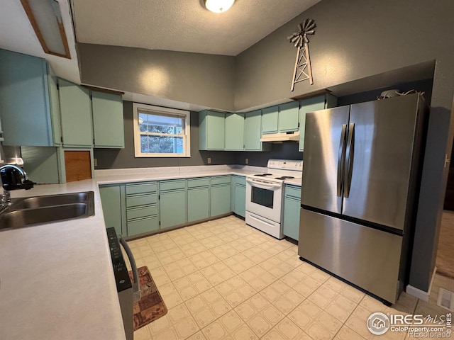 kitchen featuring sink, stainless steel fridge, green cabinets, white range with electric cooktop, and a textured ceiling