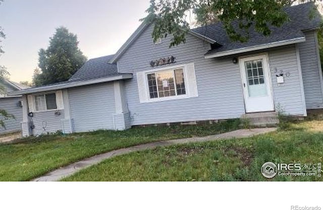 rear view of property featuring a yard