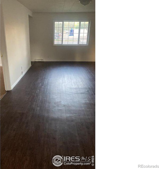 unfurnished room with dark hardwood / wood-style flooring