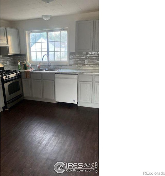 kitchen with dishwasher, sink, white cabinets, gas stove, and tasteful backsplash