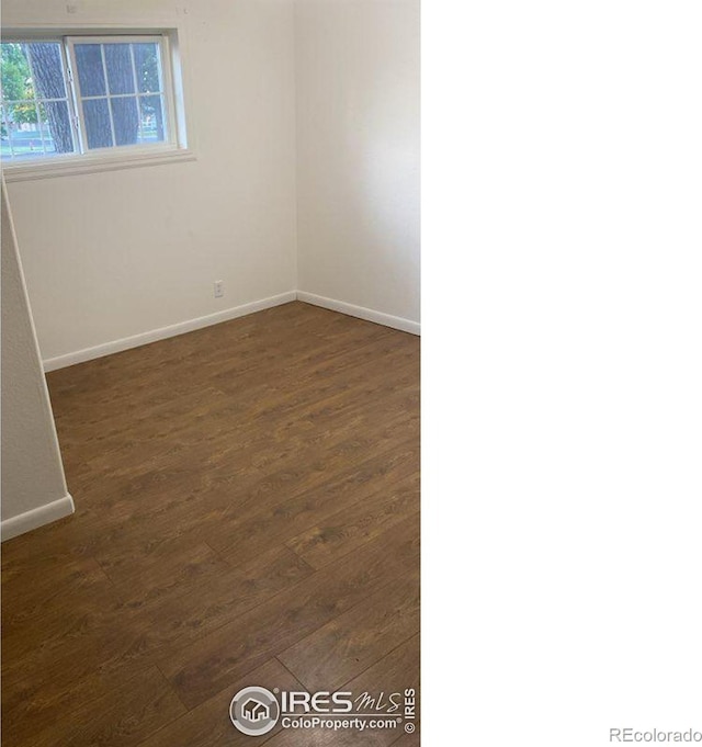 unfurnished room featuring dark hardwood / wood-style flooring