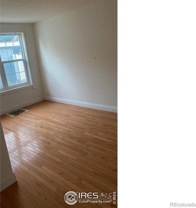 unfurnished room featuring wood-type flooring