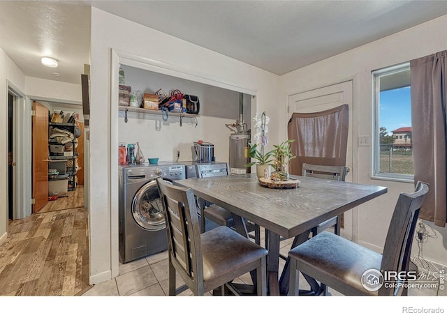 dining room with gas water heater, independent washer and dryer, and light wood-style flooring