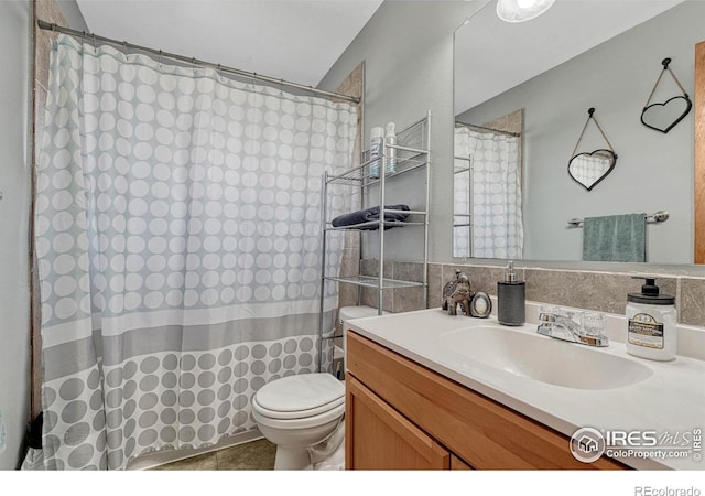 bathroom featuring vanity, toilet, and a shower with curtain