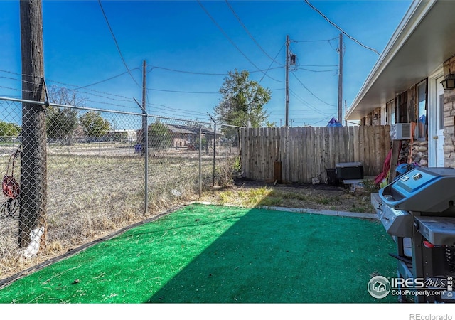 view of yard featuring cooling unit and fence