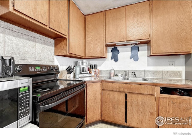 kitchen with stainless steel microwave, a sink, and black electric range oven