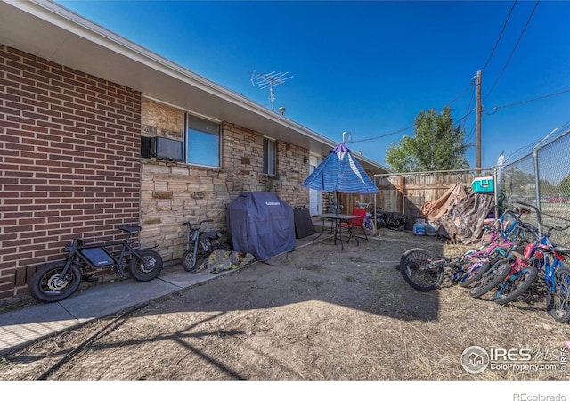 view of patio with a grill and fence