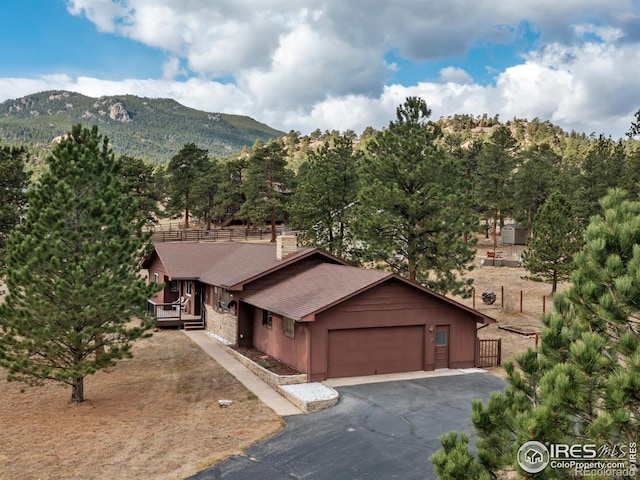 view of front of property with a mountain view and a garage