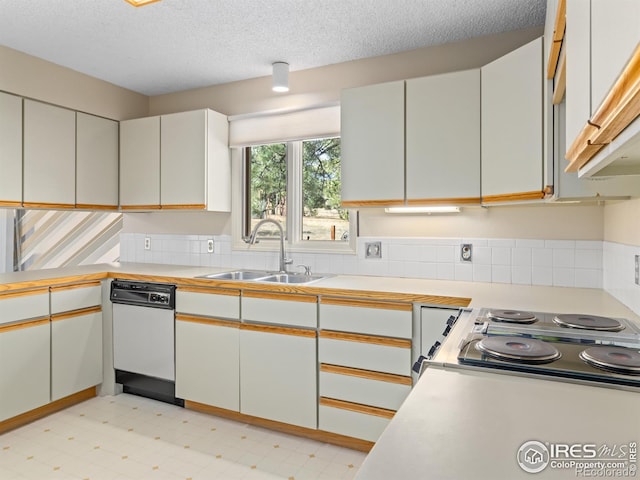 kitchen featuring white cabinets, sink, white dishwasher, and a textured ceiling