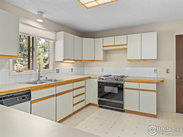 kitchen featuring white dishwasher, white cabinetry, stove, and sink