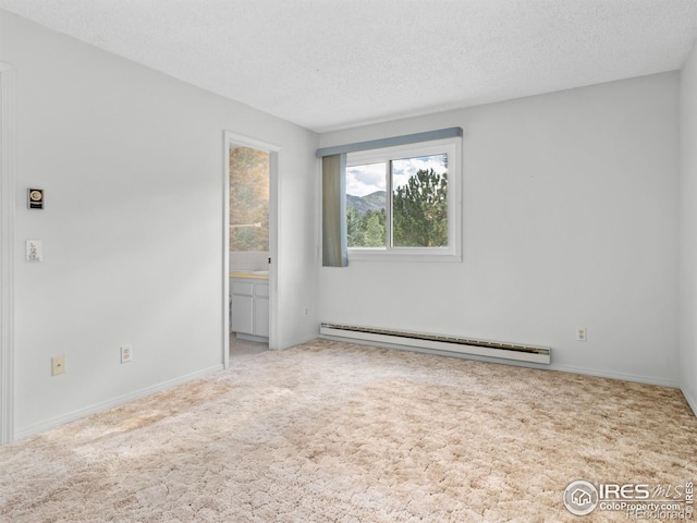 unfurnished room with light carpet, a baseboard heating unit, and a textured ceiling