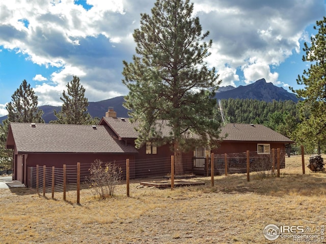 rear view of house featuring a mountain view