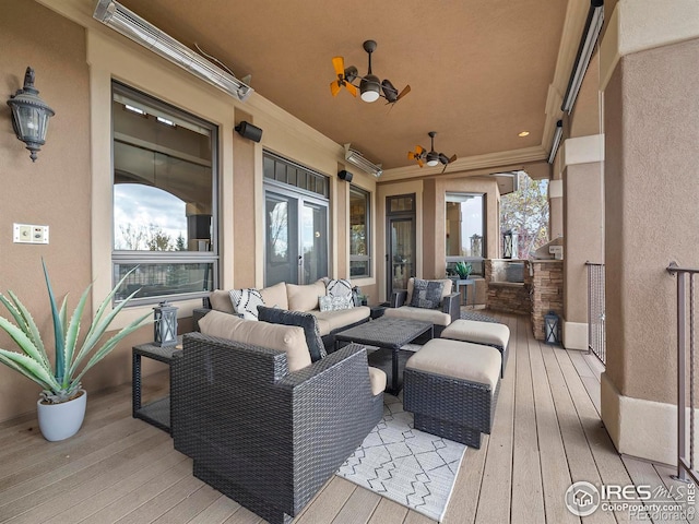 wooden terrace with an outdoor hangout area and ceiling fan