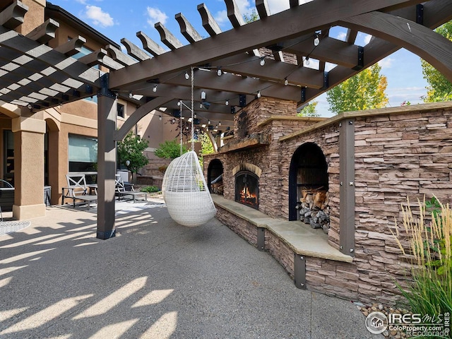 view of patio / terrace with a pergola and an outdoor stone fireplace