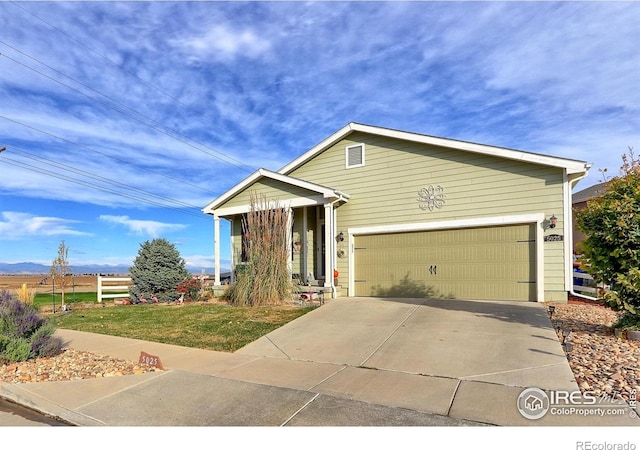 view of front of house featuring a front yard and a garage