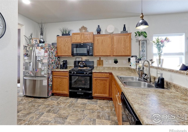 kitchen with decorative light fixtures, black appliances, and sink