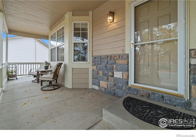 doorway to property with covered porch