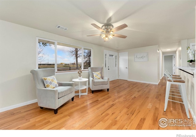 living area featuring ceiling fan and light wood-type flooring