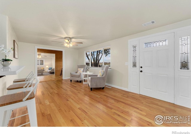 foyer with wood-type flooring and ceiling fan