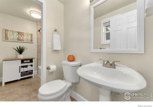 full bathroom featuring toilet, sink, and tub / shower combination