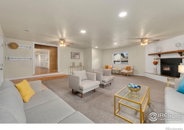 carpeted living room featuring ceiling fan
