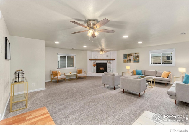 living room featuring carpet and ceiling fan