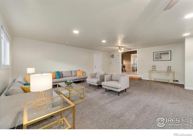 carpeted living room with ceiling fan