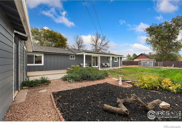 view of yard with a sunroom and a patio area