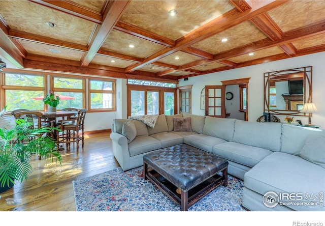 living room with beam ceiling, coffered ceiling, hardwood / wood-style flooring, and french doors