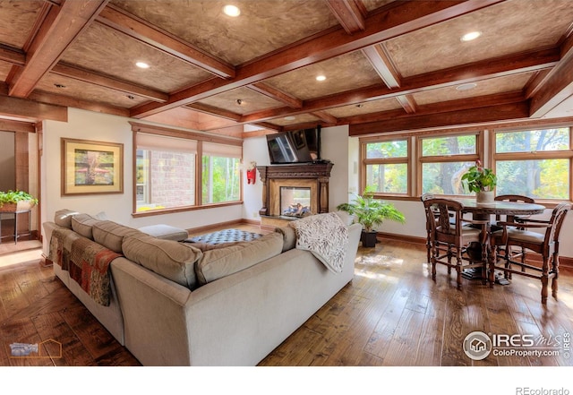 living room with hardwood / wood-style floors, beamed ceiling, and coffered ceiling