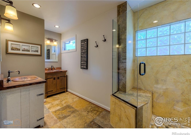 bathroom featuring vanity and a shower with shower door