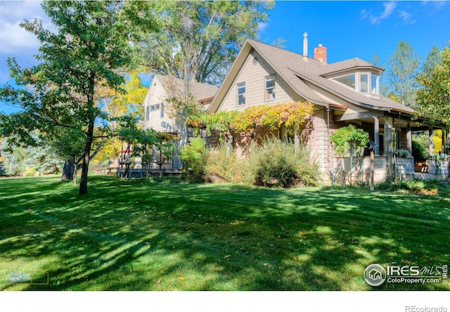 view of side of home with a lawn