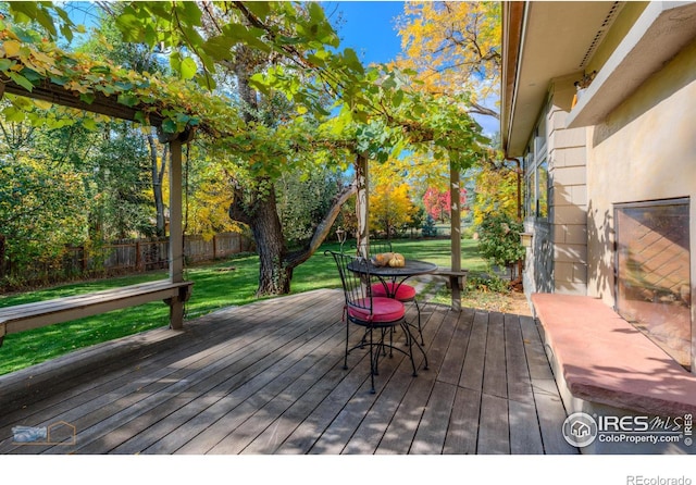 wooden deck featuring a yard