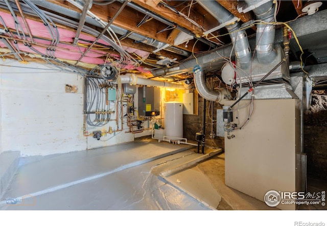 utility room featuring electric panel, heating unit, and water heater