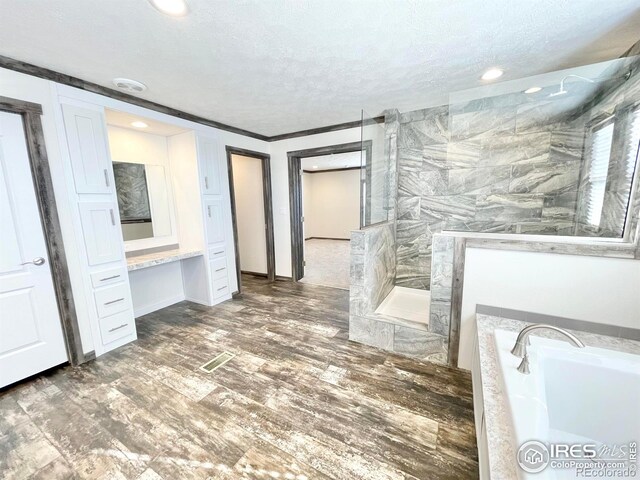 bathroom with hardwood / wood-style floors, shower with separate bathtub, a textured ceiling, tile walls, and crown molding