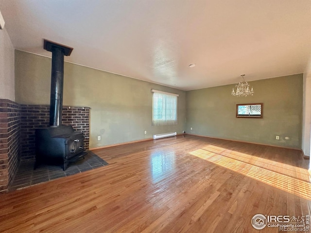 unfurnished living room featuring wood-type flooring and baseboard heating