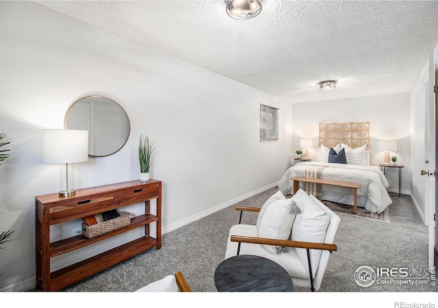 bedroom with a textured ceiling and carpet floors