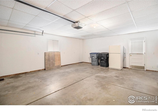 garage featuring a garage door opener and white fridge