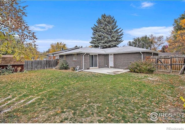 rear view of property with a patio area and a lawn