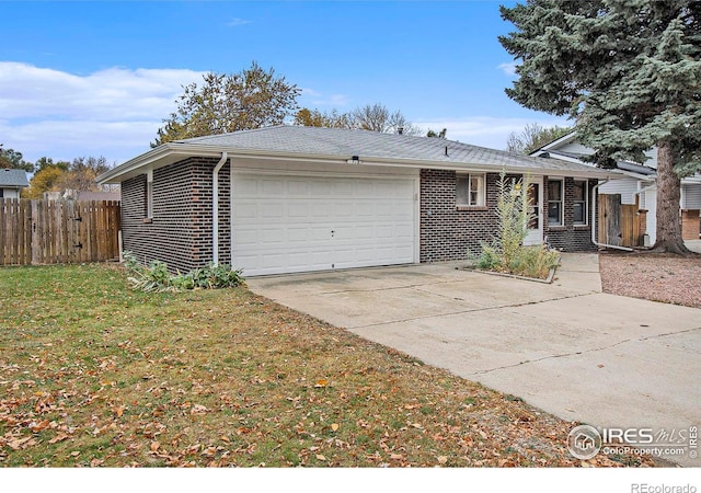 view of front of property with a front yard and a garage