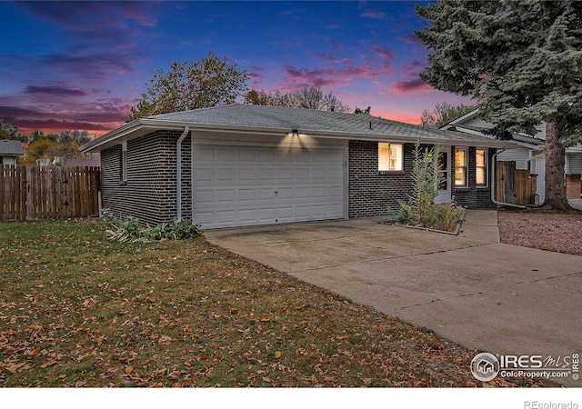 view of front of property featuring a yard and a garage