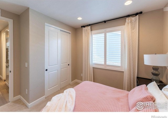 bedroom with a closet and light carpet